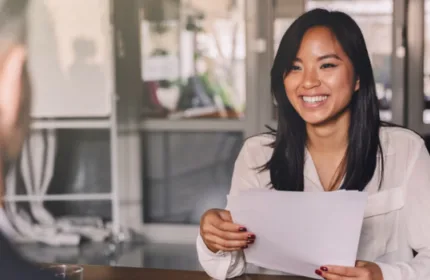 Job candidate reviewing documents during a professional interview, representing Beacon Hill’s commitment to a positive hiring experience