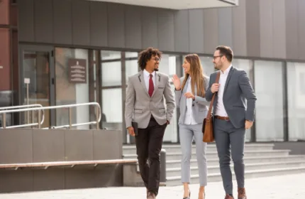Professionals walking together outside a modern office building, representing collaboration and workplace culture at Beacon Hill