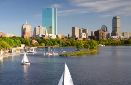 Boston skyline along the Charles River with sailboats, highlighting Beacon Hill executive search firm ranking in 2026
