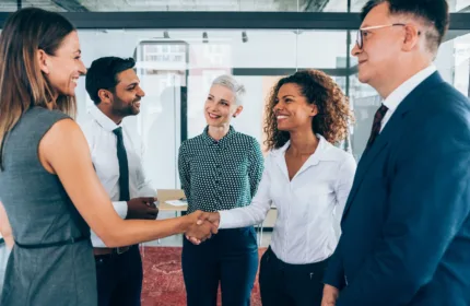 Professionals shaking hands and meeting in an office, representing Beacon Hill's direct hire and permanent placement services recognized by Staffing Industry Analysts among the largest direct hire firms in the United States.
