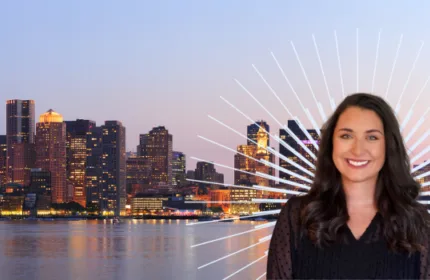 Professional headshot accompanying the announcement of OneBeacon's promotion of Jordan Skaggs to Solutions Partnership Director, set against a Boston skyline backdrop.
