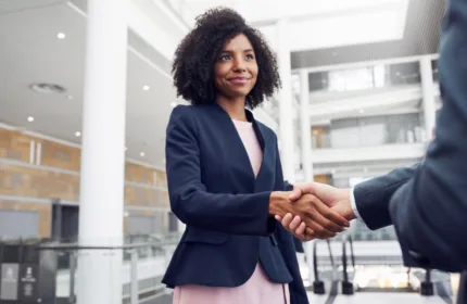 Professional handshake in a modern office setting representing Beacon Hill’s recognition as one of the world’s largest staffing firms.
