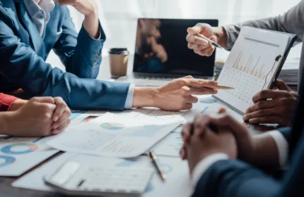 Business leaders reviewing workforce planning reports, labor market data, and staffing strategy analytics during a contingent workforce planning meeting for 2027.