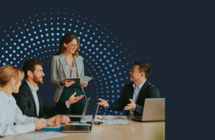 Professionals in a meeting discussing employment data and labor market trends.