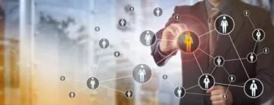 Business professional analyzing a digital network of people icons, representing strategic talent mapping and workforce connection in a corporate environment