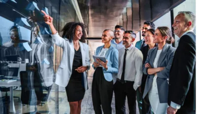 Business team collaborating and reviewing ideas during a strategy meeting, symbolizing the innovation and agility MSPs bring to contingent workforce management.