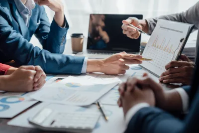 Business leaders reviewing workforce planning reports, labor market data, and staffing strategy analytics during a contingent workforce planning meeting for 2027.