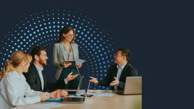 Professionals in a meeting discussing employment data and labor market trends.