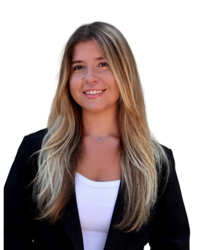Natalie smiling in a professional headshot, wearing a black blazer and white top.