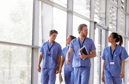 Healthcare professionals in a hospital corridor, symbolizing IT and data solutions for medical systems.