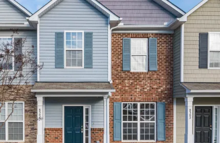 A row of homes, representing administrative and community support for public housing programs.