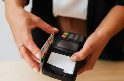 A person using a payment terminal, representing financial and operational expertise for healthcare payers.