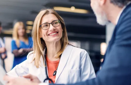 Medical team meeting with a patient, representing financial support for healthcare provider organizations.