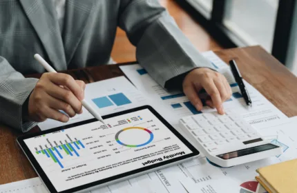 A professional analyzing data and financial reports, representing consulting and analysis in financial services.