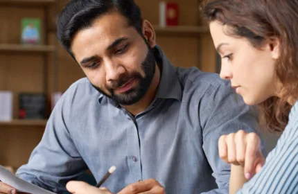 Colleagues reviewing financial paperwork, symbolizing financial oversight for professional services firms.