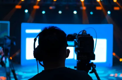 Crew members working under stage lights, representing administrative support for entertainment productions.