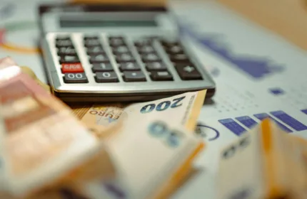 A laptop and documents on a desk, representing administrative and operational support for hedge funds.