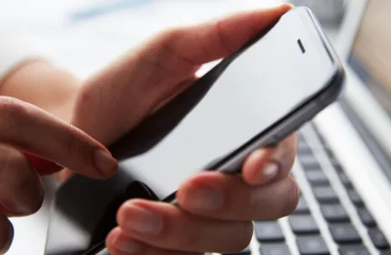 Engineer testing mobile device performance and connectivity in a lab environment.