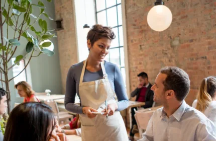 Restaurant staff discussing operations, representing financial planning for dining establishments.