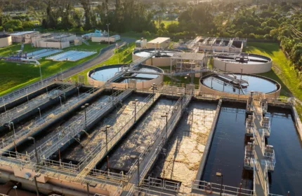 A cityscape with solar panels and green infrastructure, representing staffing and consulting for municipal initiatives.