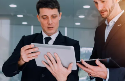 Professionals discussing property plans, symbolizing financial expertise across real estate sectors.