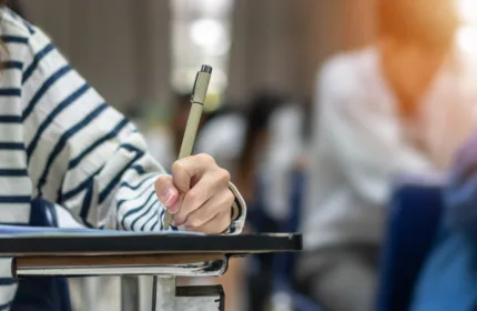 Student using a digital device in a classroom environment representing education technology, digital learning and institutional modernization initiatives