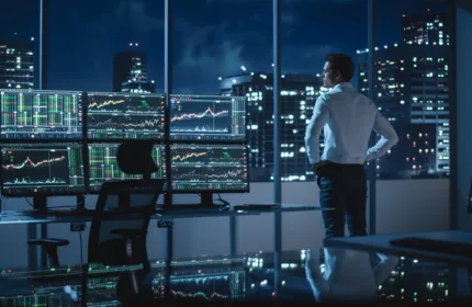 A financial trading workspace features multiple monitors displaying market data and investment analytics, representing hedge fund operations, portfolio management and quantitative trading strategies.