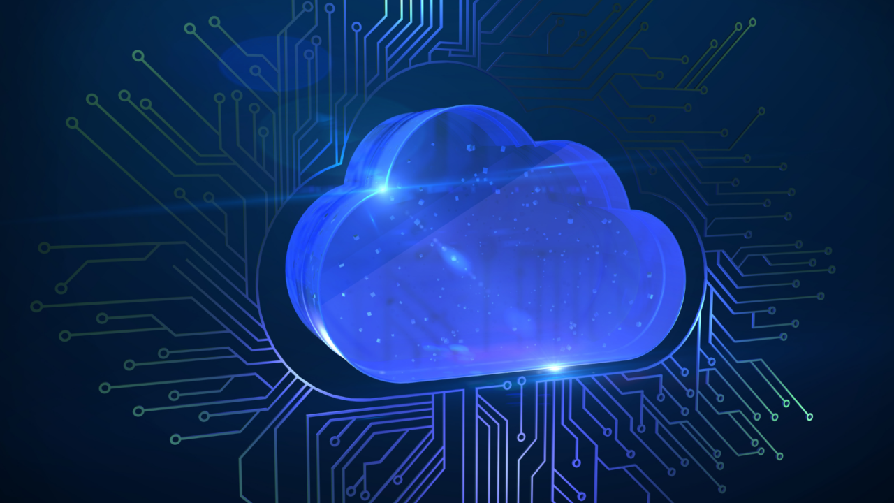 Blue glowing cloud icon surrounded by interconnected circuit lines on a dark background, symbolizing cloud computing technology and digital network infrastructure.