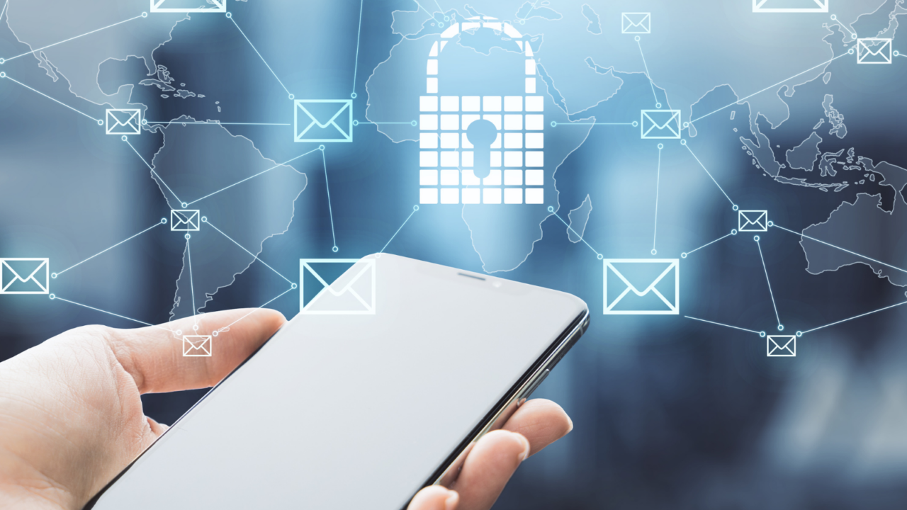 Hand holding a smartphone with a digital lock icon and interconnected email symbols over a world map background, representing cybersecurity, secure communication, and data protection.