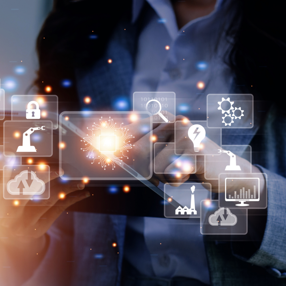 Person holding a tablet with glowing digital icons representing automation, cloud computing, security, analytics, and industrial processes, symbolizing organizational development and change management in a technology-driven environment.