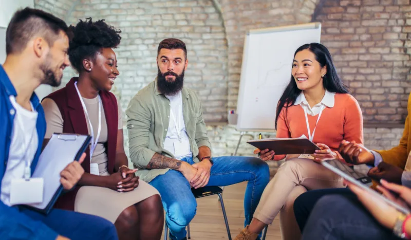 A group of professionals engaging in a team discussion, reflecting Beacon Hill’s collaborative culture and career development opportunities.