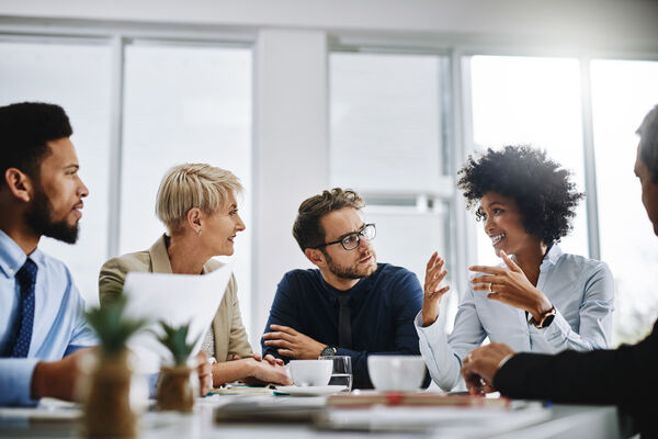 Business professionals collaborating around a conference table during a strategic workforce planning discussion.