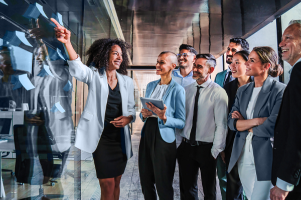 Business team collaborating and reviewing ideas during a strategy meeting, symbolizing the innovation and agility MSPs bring to contingent workforce management.